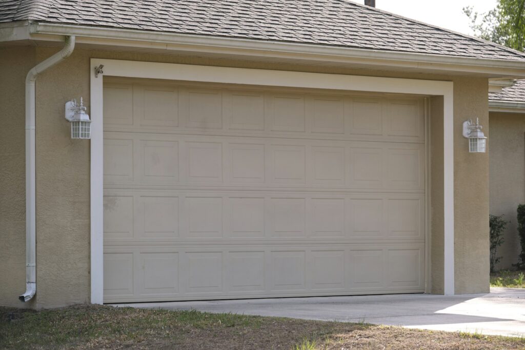 Wide garage double door and concrete driveway of new modern american house