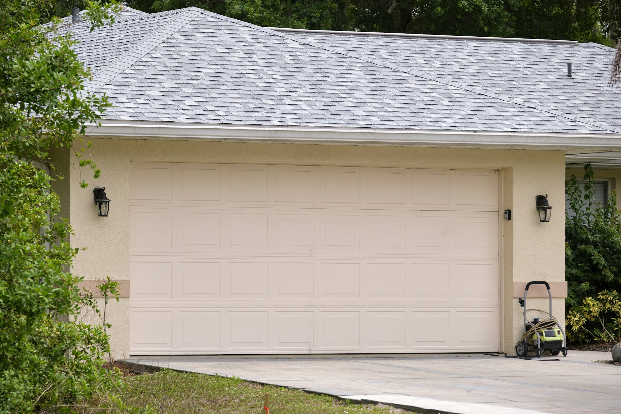 Wide garage double door and concrete driveway of new modern american house